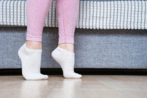 The benefits of bamboo socks - young woman walking in bamboo socks