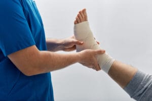 Person with bandage on foot to prevent foot and ankle injury