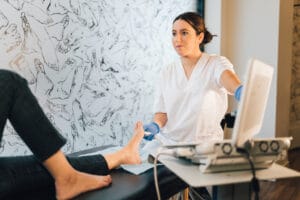 Podiatrist discussing with a patient regarding how to treat bunions