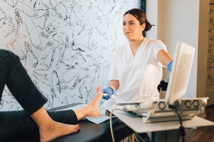 Podiatrist discussing with a patient regarding how to treat bunions