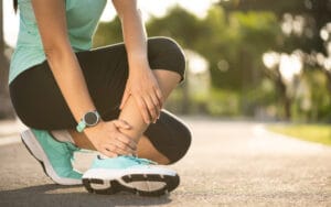 Woman suffering with foot problem during long distance running