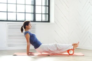 the benefits of foam rolling for your feet, demonstrated by a young woman