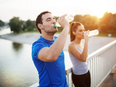 Two people drinking water