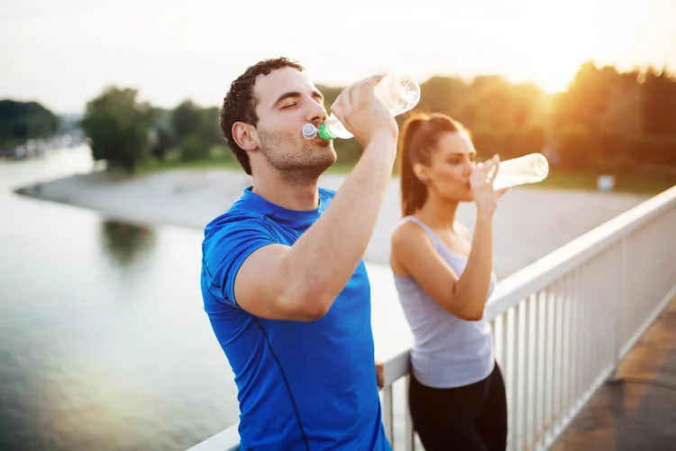 Two people drinking water