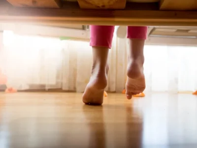 woman with flat feet getting out of bed