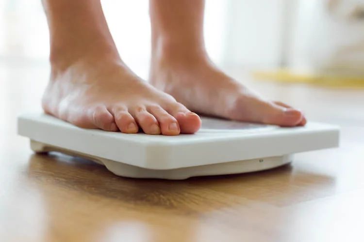 woman weighing herself