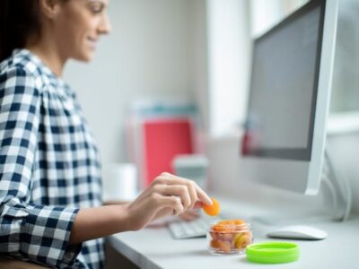 Woman eating food and snacks in the office