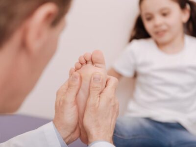 Podiatrist assessing a childs foot