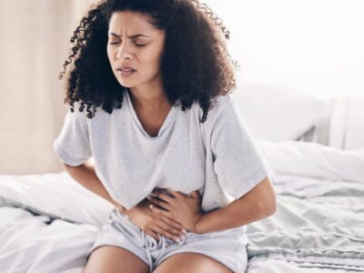 Young woman with stomach cramps