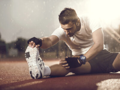 Make athlete with tight leg muscle stretching