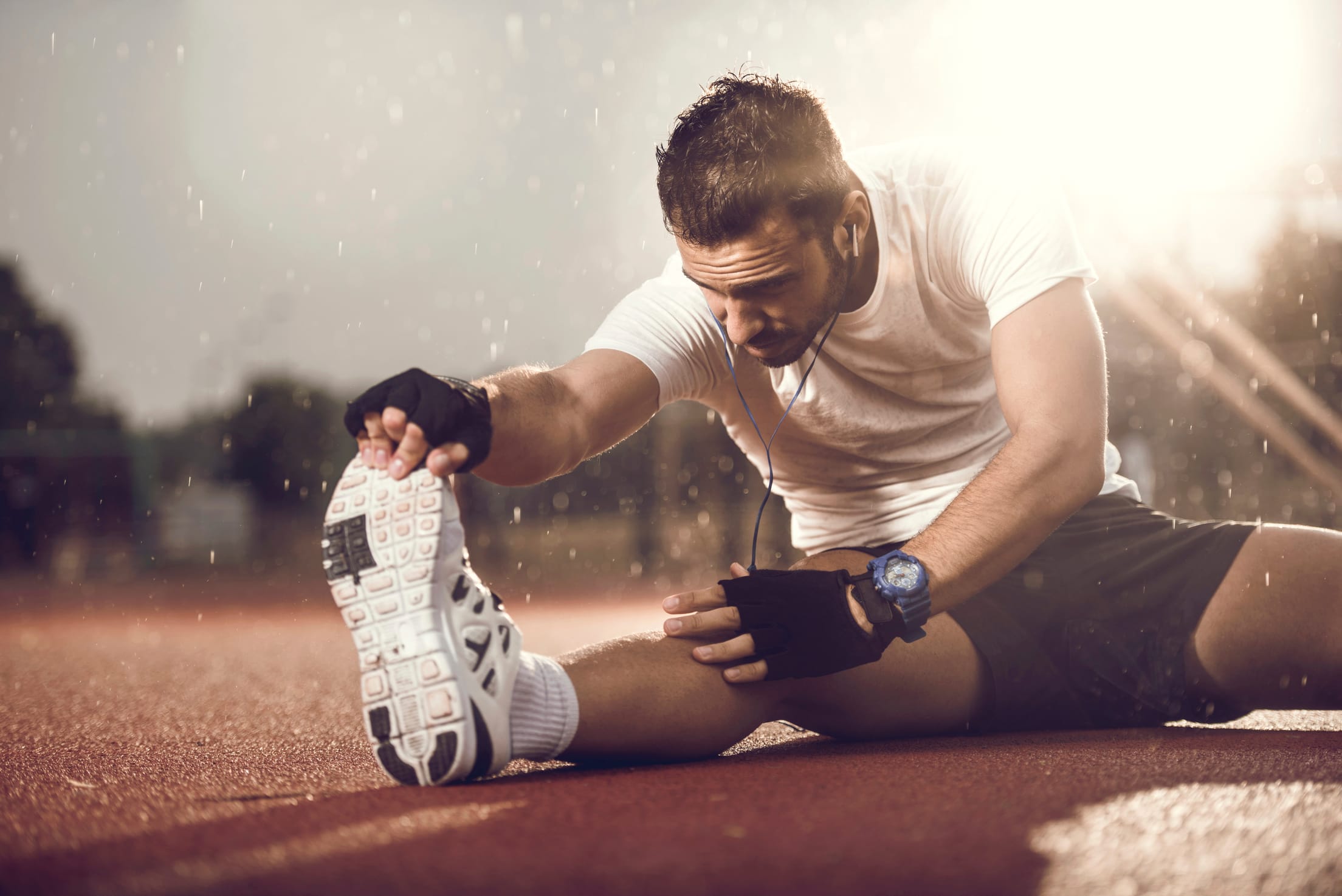 Make athlete with tight leg muscle stretching