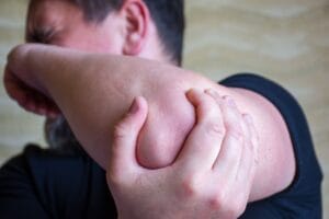 Man with pins and needles in his elbow