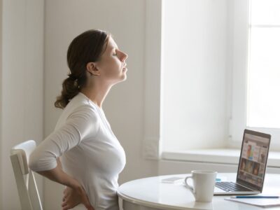 Young woman with pain in her back