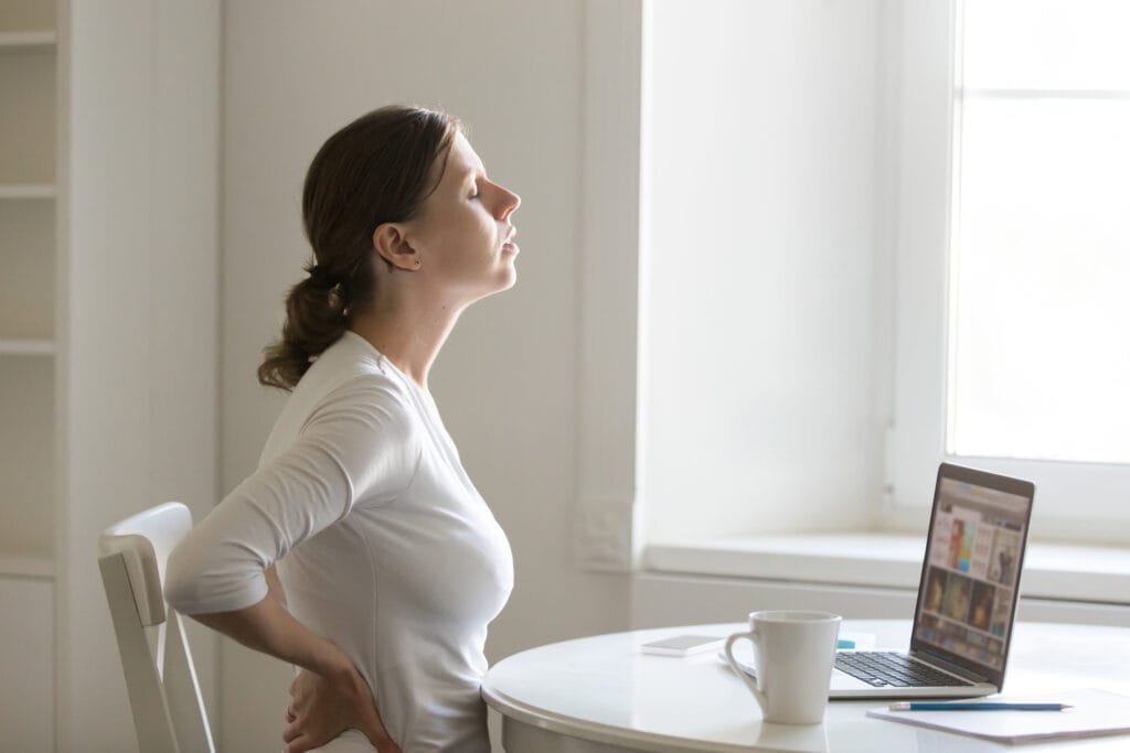 Woman with back pain stretching