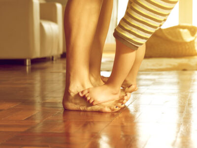 Child standing on parents feet
