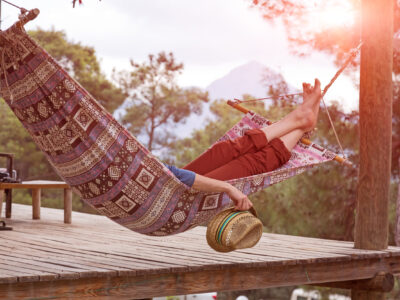 Person in a hammock relaxing barefoot