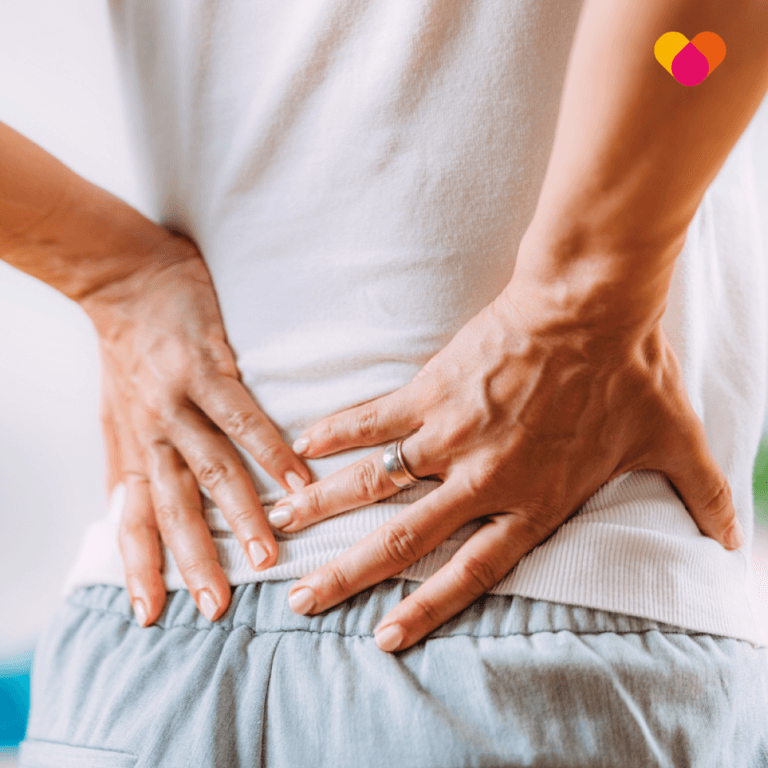 Man with hands on lower back because of back pain or ruptured disc