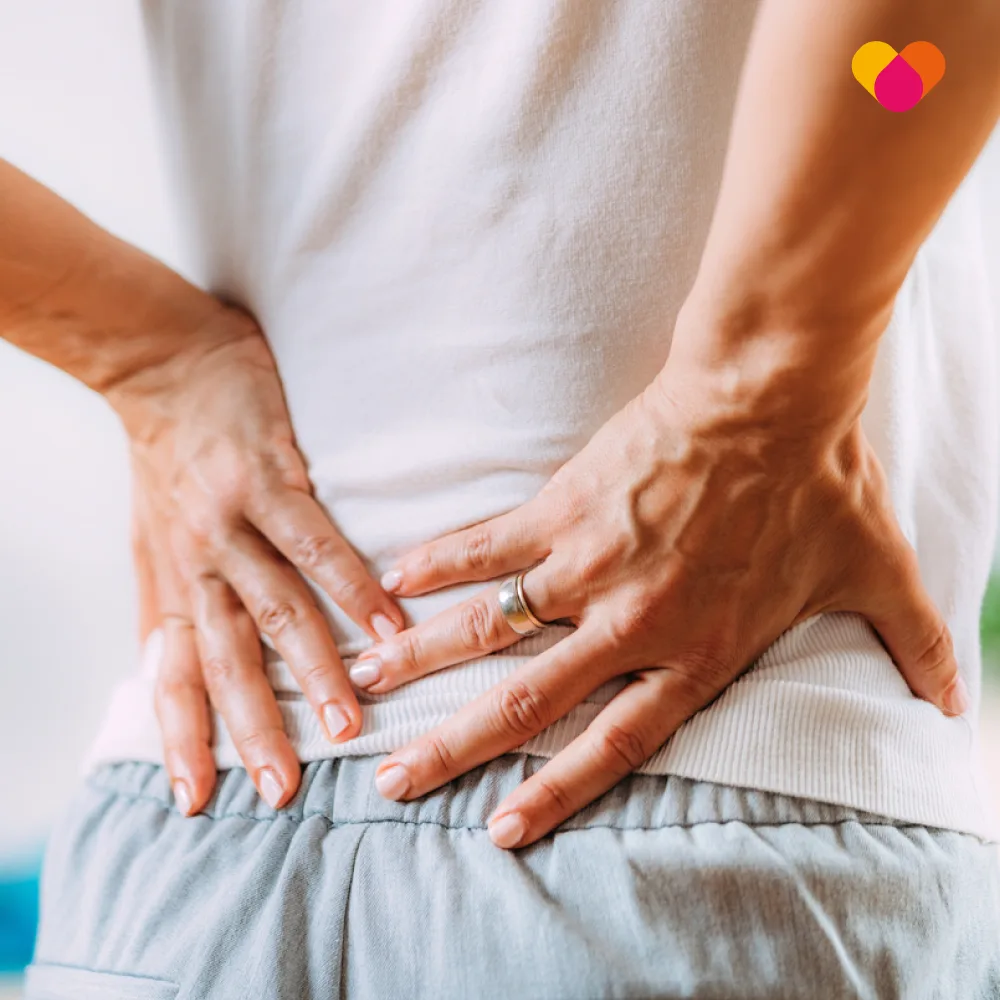 Man with hands on lower back because of back pain or ruptured disc