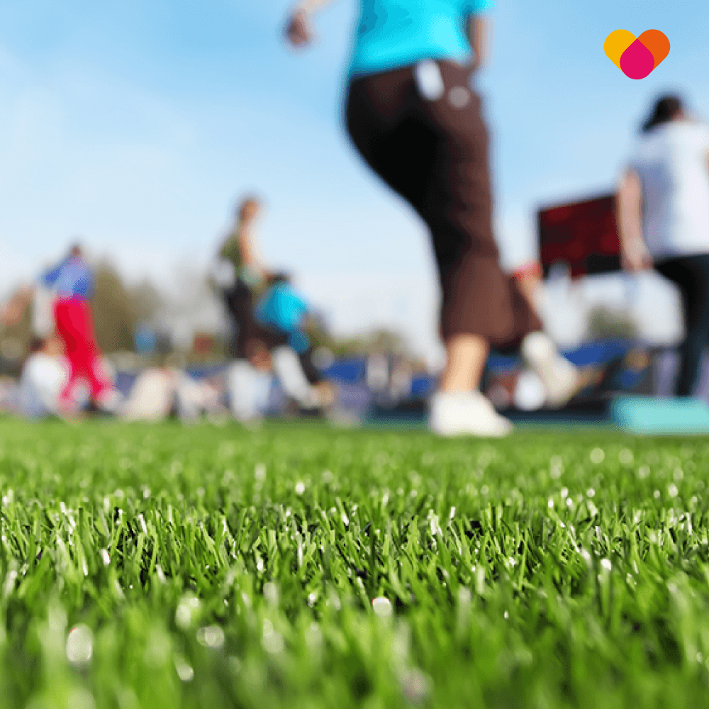A group of people training pitchside with a physiotherapist