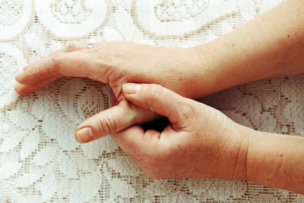 Woman holding her painful thumb