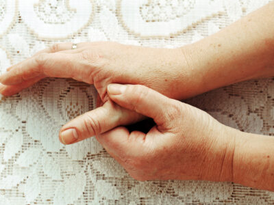 Woman holding her painful thumb