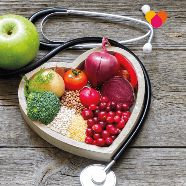Healthy food on a wooden table in the shape of a heart