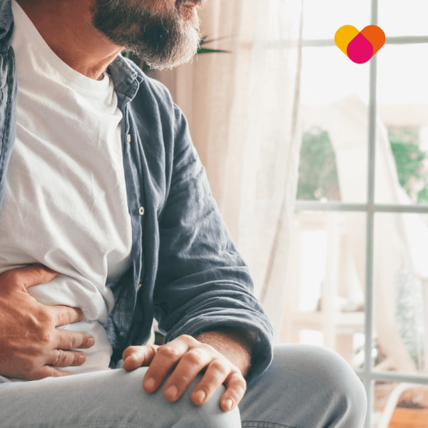 Diverticulitis Man holding his abdomen feeling stomach pain relating to constipation